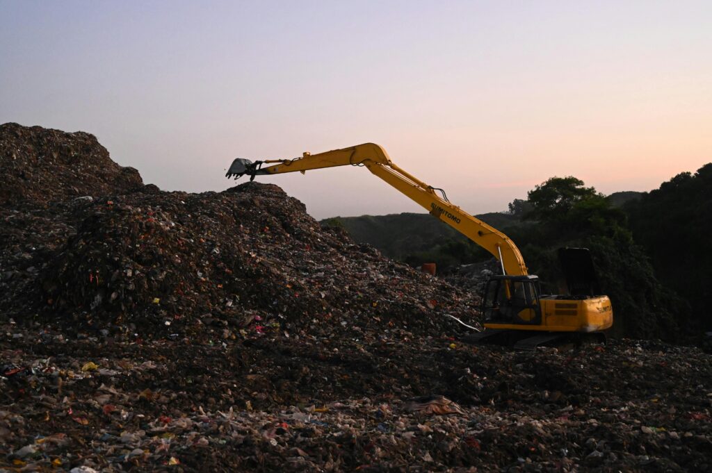 Excavator on Work on a Landfill