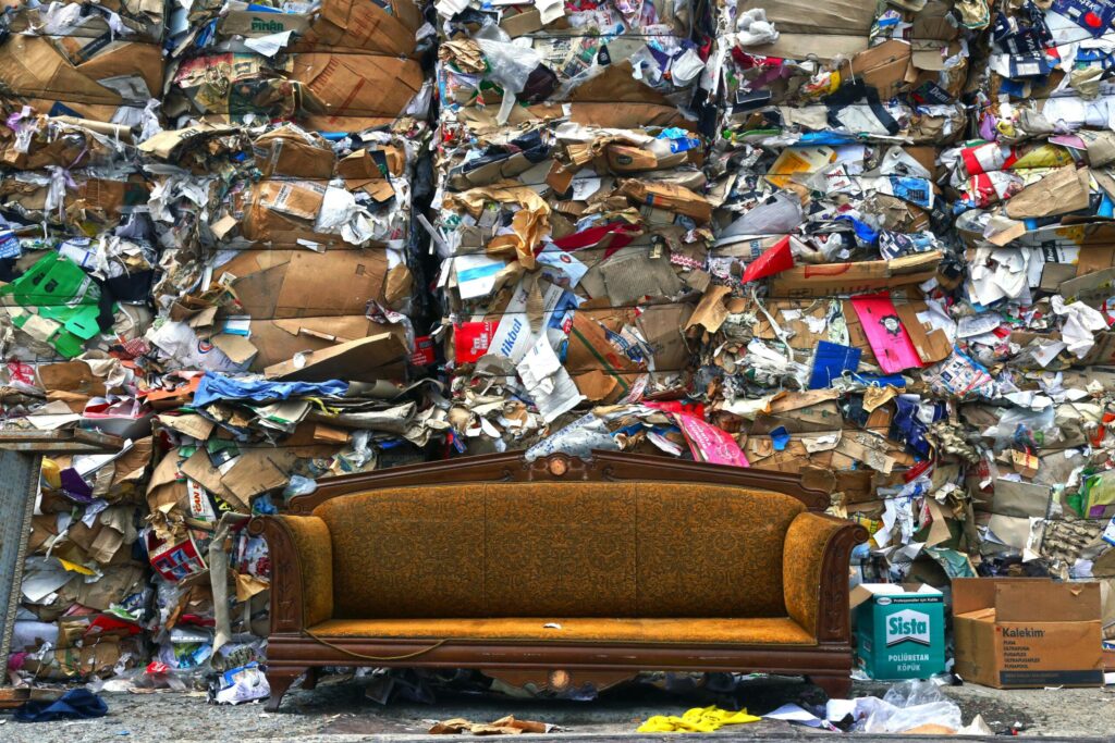 pexels-photo-2264665-2264665 A vintage sofa placed against a backdrop of compressed cardboard waste in Istanbul.